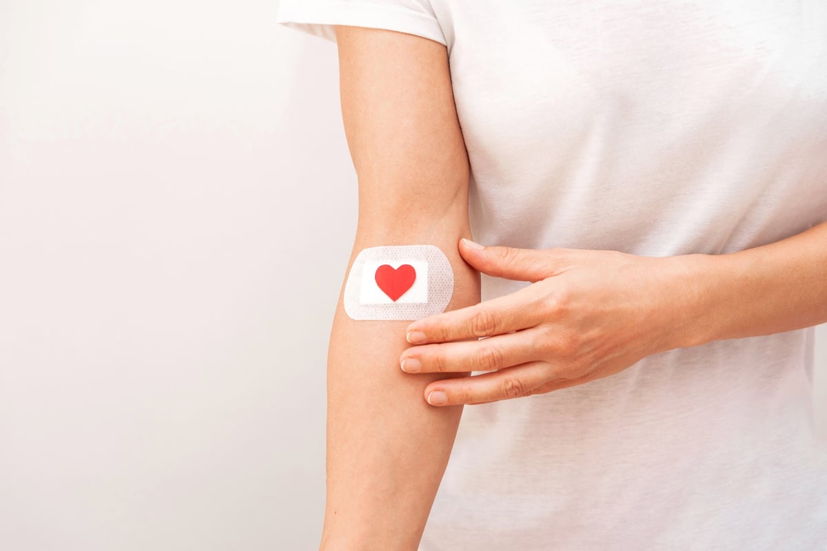 Patient with bandage and heart after medical procedure