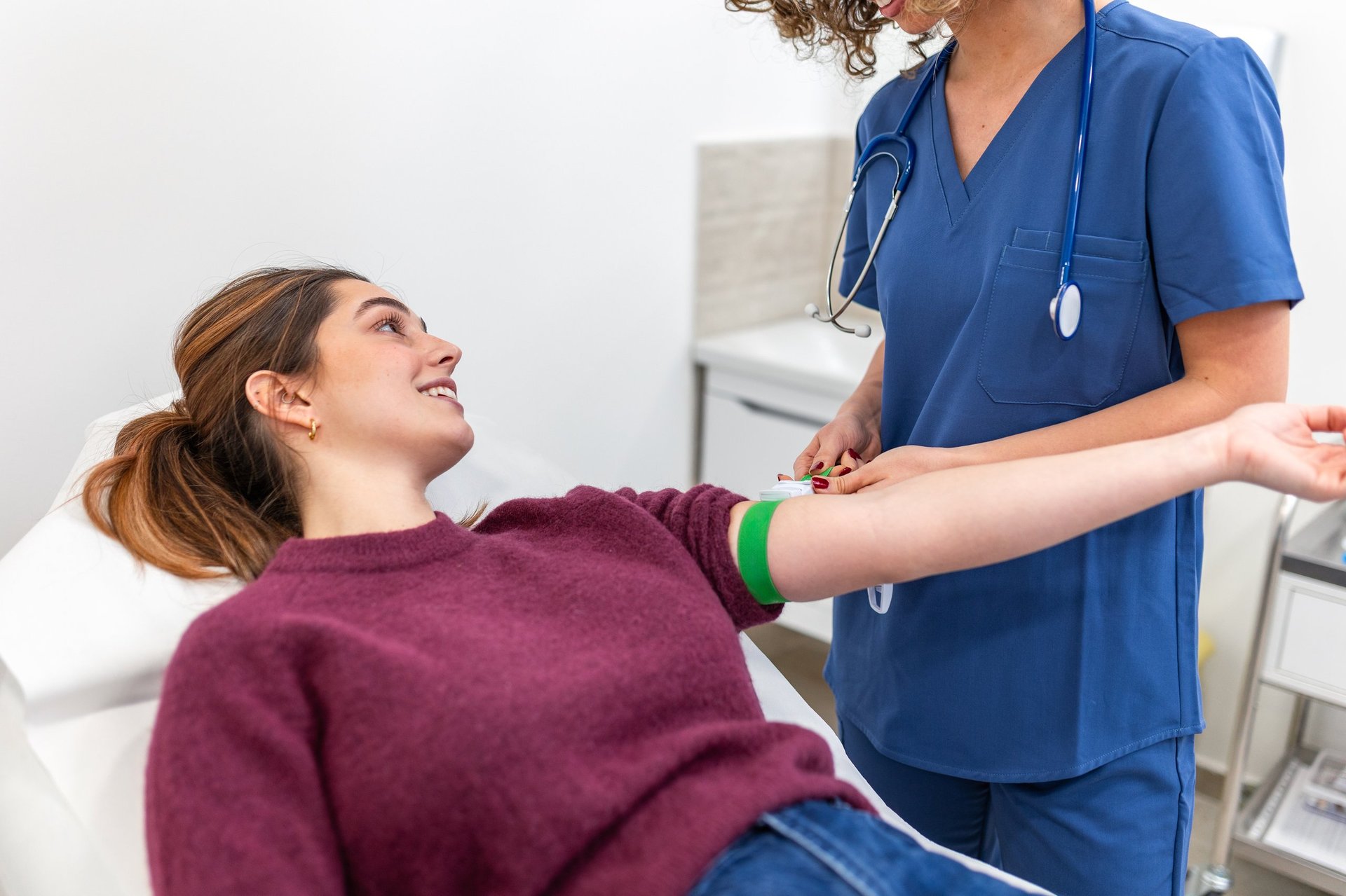 Doctor preparing patient for blood test in clinic